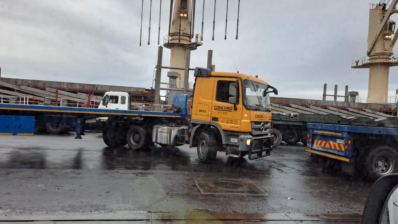 Commercial transport truck stationed at industrial port terminal facility
